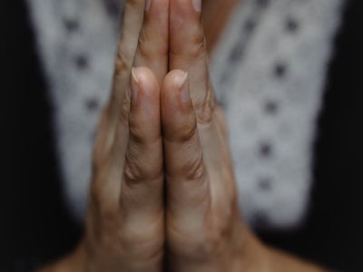 Close-up of hands in a meditative mudra position.